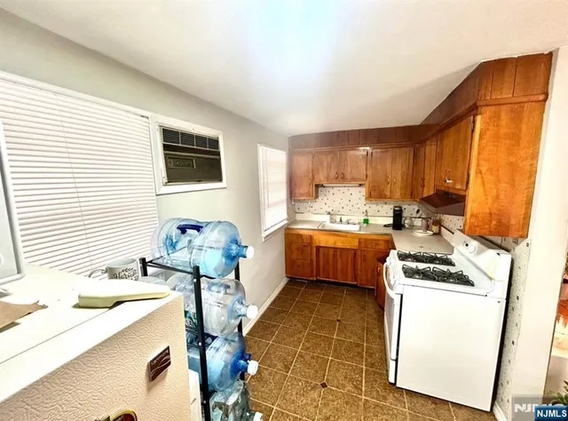 a kitchen that has a sink and a stove top oven