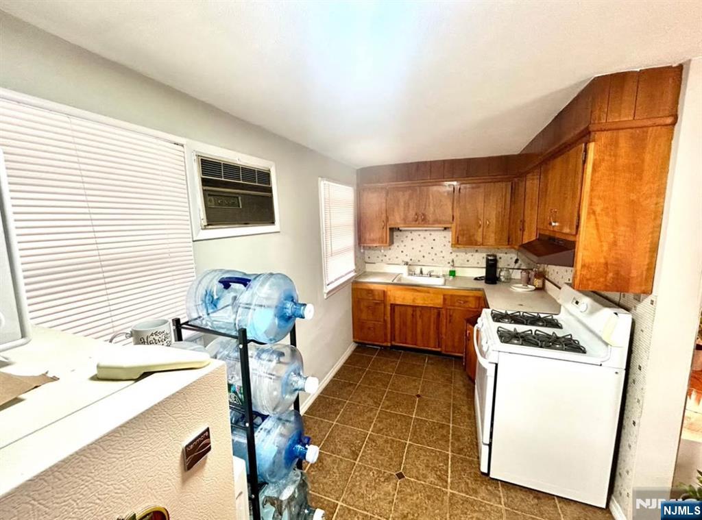 134-136 Canterbury Avenue, Unit 2 North Arlington, NJ 07031 - Photo 5 of 8 a kitchen that has a sink and a stove top oven