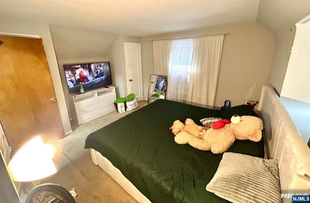 134-136 Canterbury Avenue, Unit 2 North Arlington, NJ 07031 - Photo 7 of 8 a living room with a couch and a floor to ceiling window