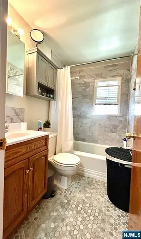 a bathroom with a sink a toilet and bathtub