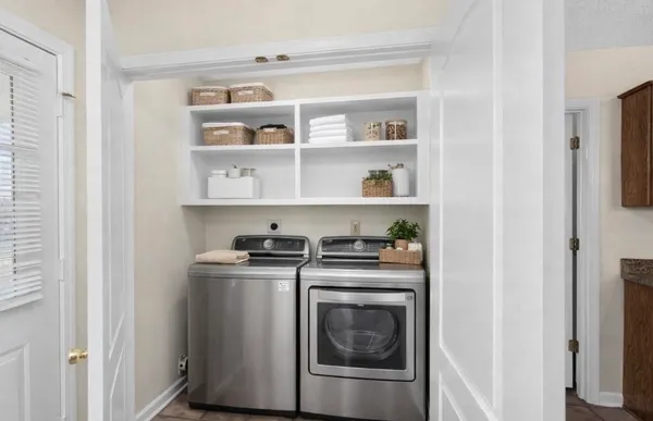a view of a storage and utility room with washer and dryer