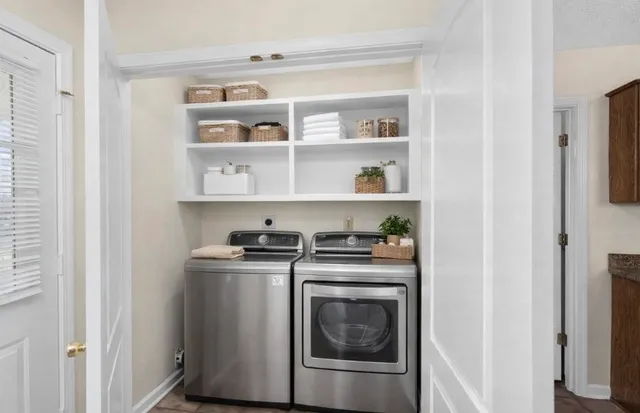 a view of a storage and utility room with washer and dryer