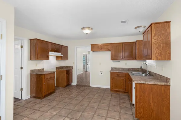 a kitchen with a refrigerator sink and stove