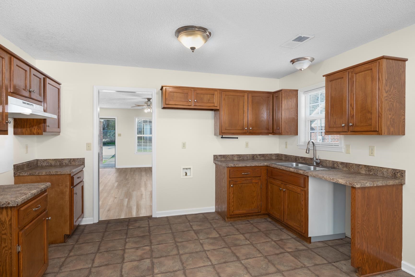 212 Feezor Street Covington, TN 38019 - Photo 15 of 31 a kitchen with stainless steel appliances granite countertop a sink stove and refrigerator