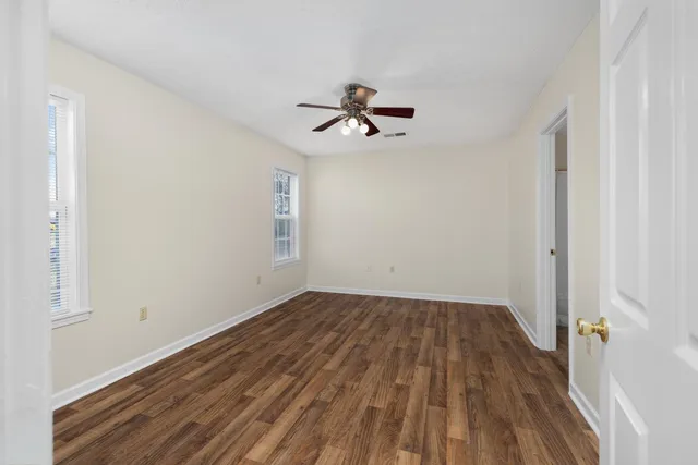 wooden floor in an empty room with a window