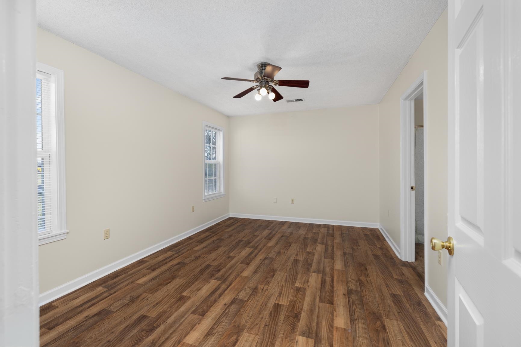 212 Feezor Street Covington, TN 38019 - Photo 18 of 31 wooden floor in an empty room with a window