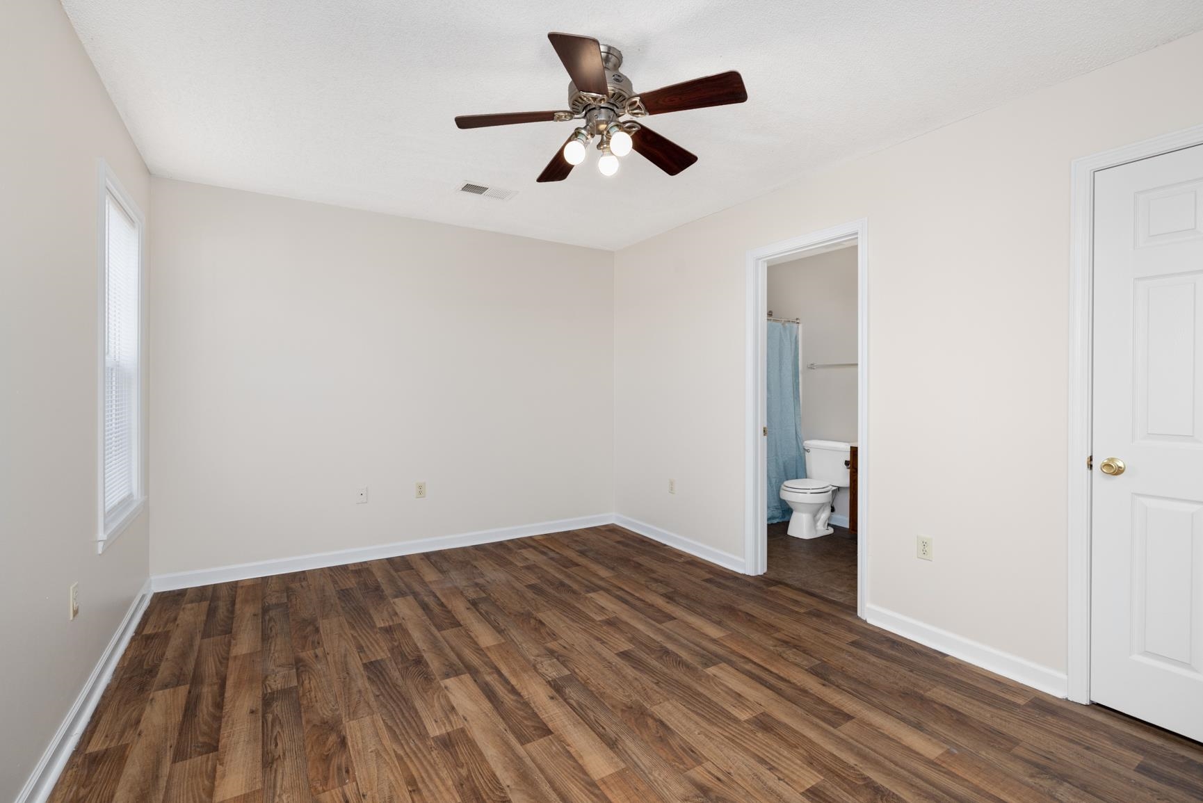 212 Feezor Street Covington, TN 38019 - Photo 19 of 31 an empty room with wooden floor and a ceiling fan