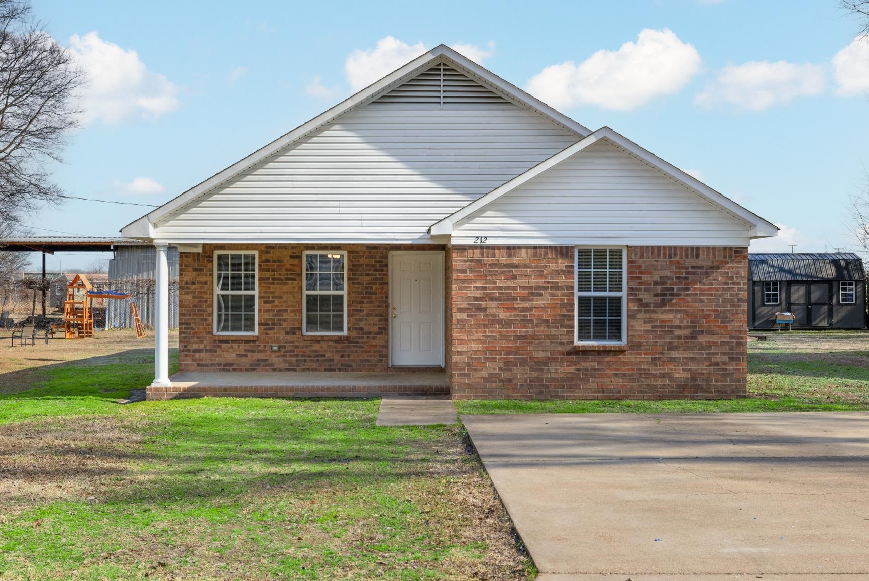 212 Feezor Street Covington, TN 38019 - Photo 2 of 31 a front view of a house with a yard