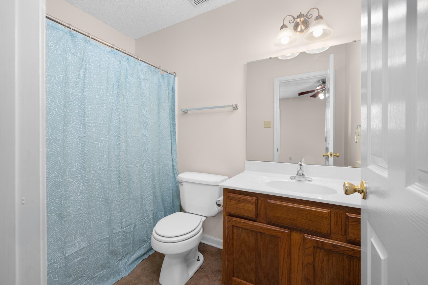 212 Feezor Street Covington, TN 38019 - Photo 22 of 31 a bathroom with a sink a toilet and shower