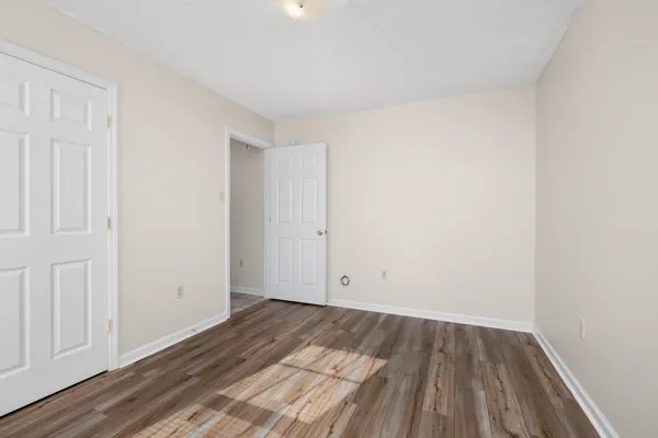 an empty room with wooden floor