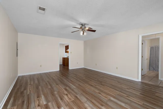 wooden floor in an empty room with a window