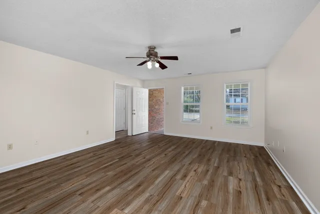 wooden floor in an empty room with a window