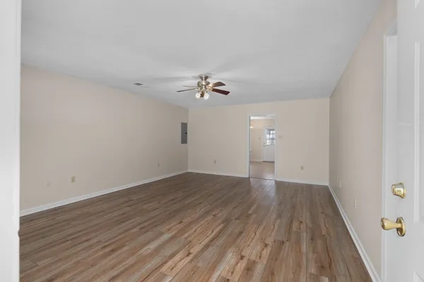 wooden floor in an empty room with a window