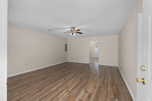 wooden floor in an empty room with a window