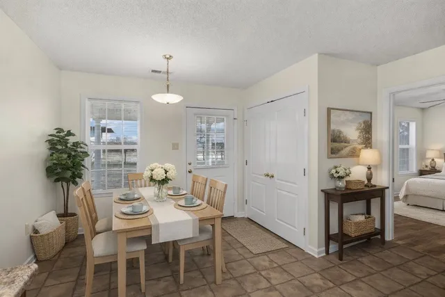 a view of a dining room with furniture and chandelier
