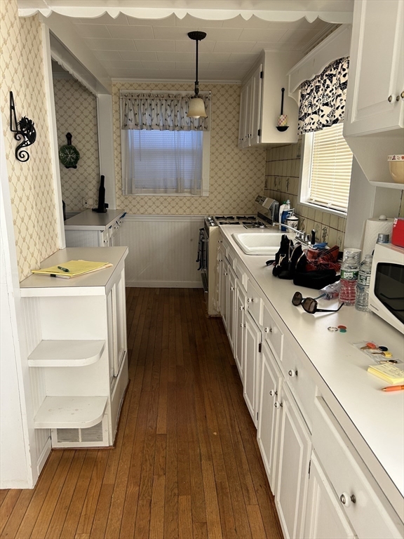 20 Shawmut Avenue New Bedford, MA 02740 - Photo 11 of 29 a kitchen with a sink a stove and cabinets