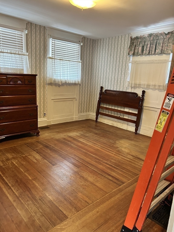 20 Shawmut Avenue New Bedford, MA 02740 - Photo 19 of 29 a view of an empty room with wooden floor and a window