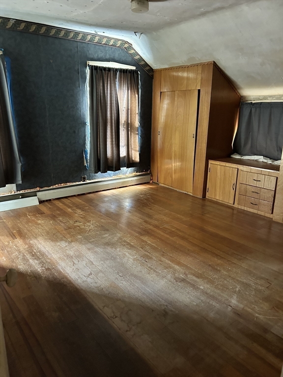 20 Shawmut Avenue New Bedford, MA 02740 - Photo 27 of 29 a view of an empty room with wooden floor and a window