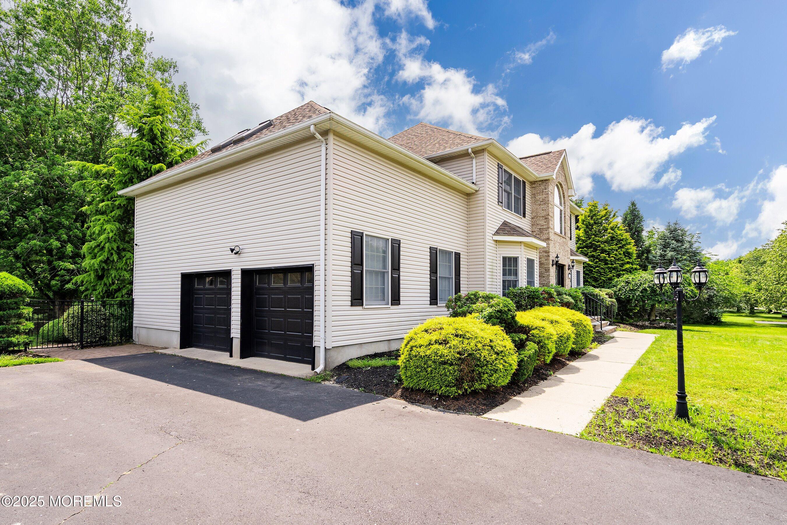 210 Rivers Glen Terrace Toms River, NJ 08755 - Photo 2 of 61 a front view of a house with a yard and garage