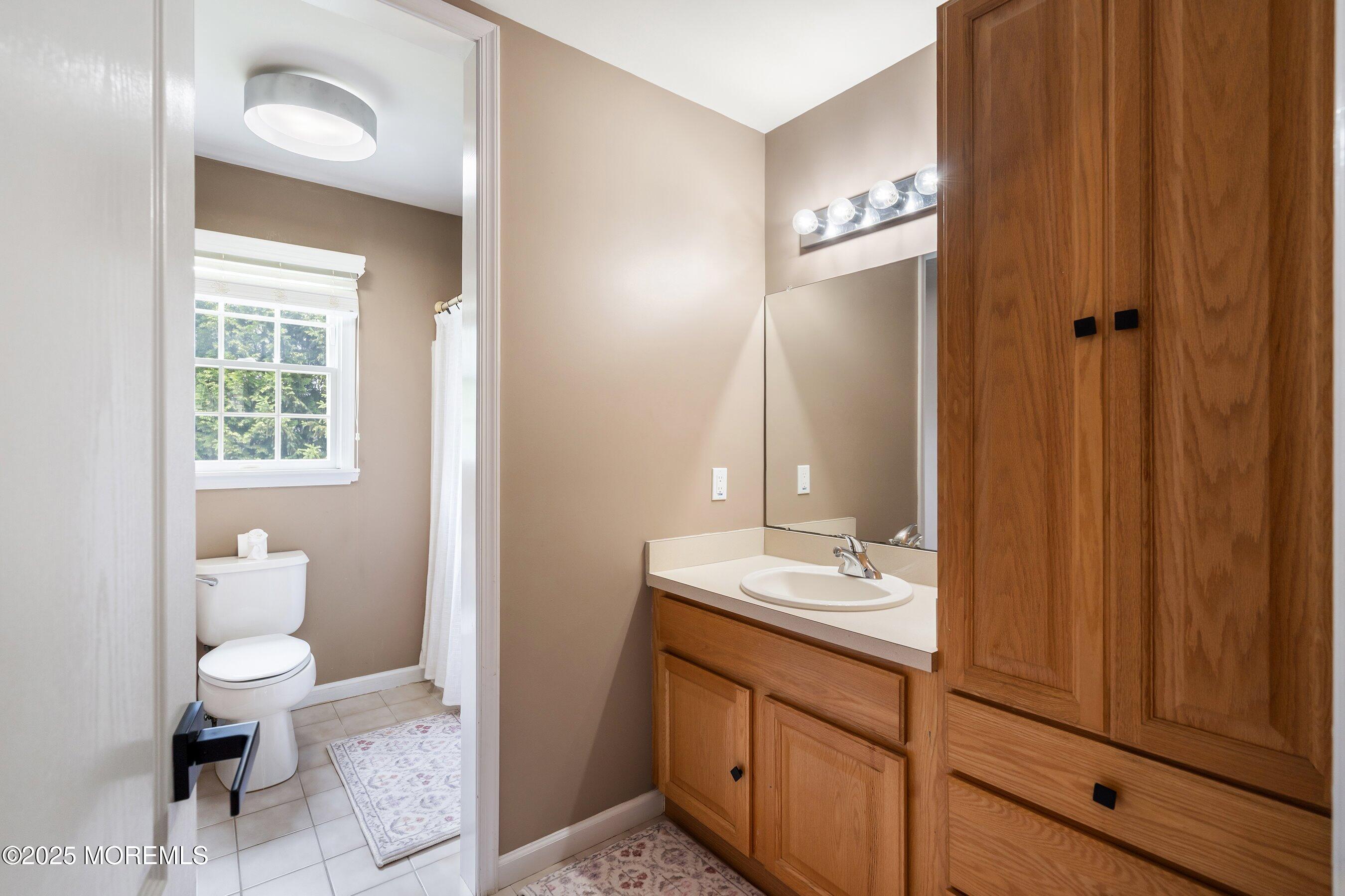 210 Rivers Glen Terrace Toms River, NJ 08755 - Photo 38 of 61 a bathroom with a toilet a sink and mirror
