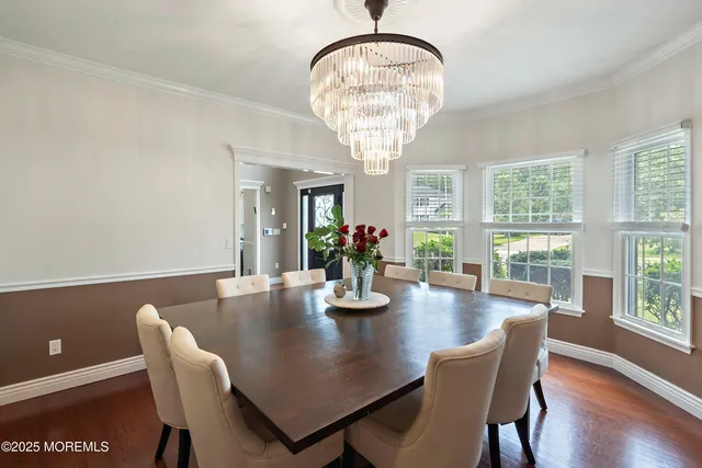a view of a dining room with furniture wooden floor and chandelier