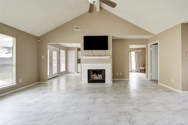 a view of a livingroom with a fireplace and window