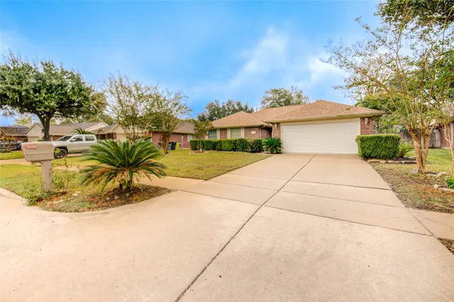 a view of a house with a yard and potted plants