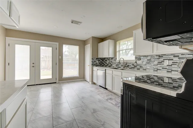 a kitchen with stainless steel appliances kitchen island granite countertop a stove a sink and a microwave