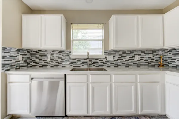 a kitchen with white cabinets