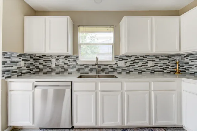 a kitchen with white cabinets
