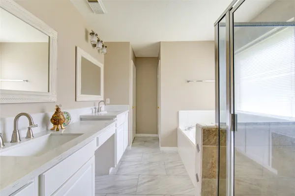 a bathroom with a double vanity sink mirror and
