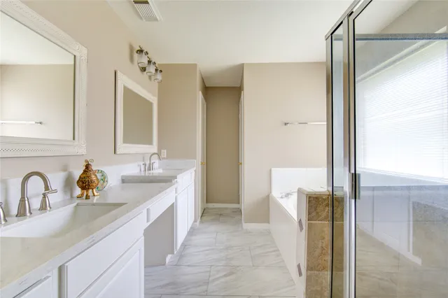 a bathroom with a double vanity sink mirror and