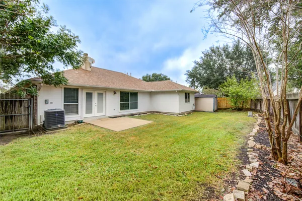 a backyard of a house with yard and outdoor seating