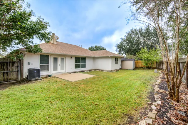 a backyard of a house with yard and outdoor seating