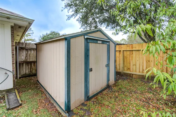 a view of a yard with wooden fence