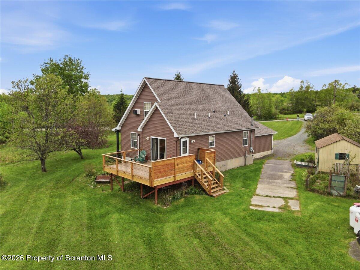 5231 Fiddle Lake Road Thompson, PA 18465 - Photo 26 of 34 a aerial view of a house with a yard table and chairs