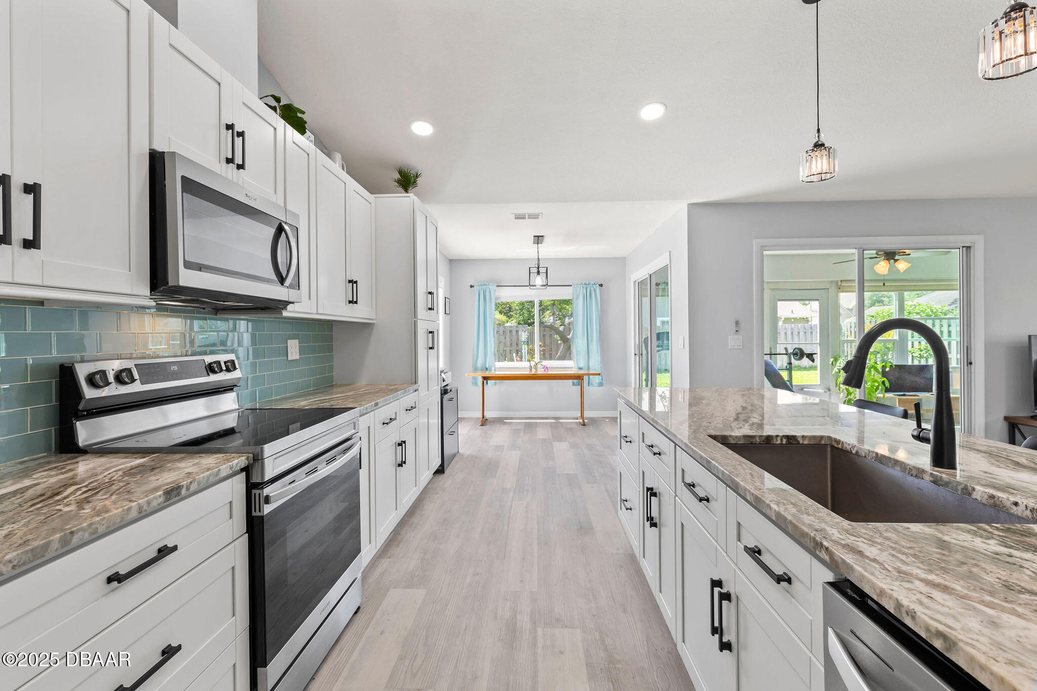 35 China Moon Drive Ormond Beach, FL 32174 - Photo 11 of 40 a large kitchen with stainless steel appliances granite countertop a lot of counter space a sink and dishwasher a stove top oven with wooden floor
