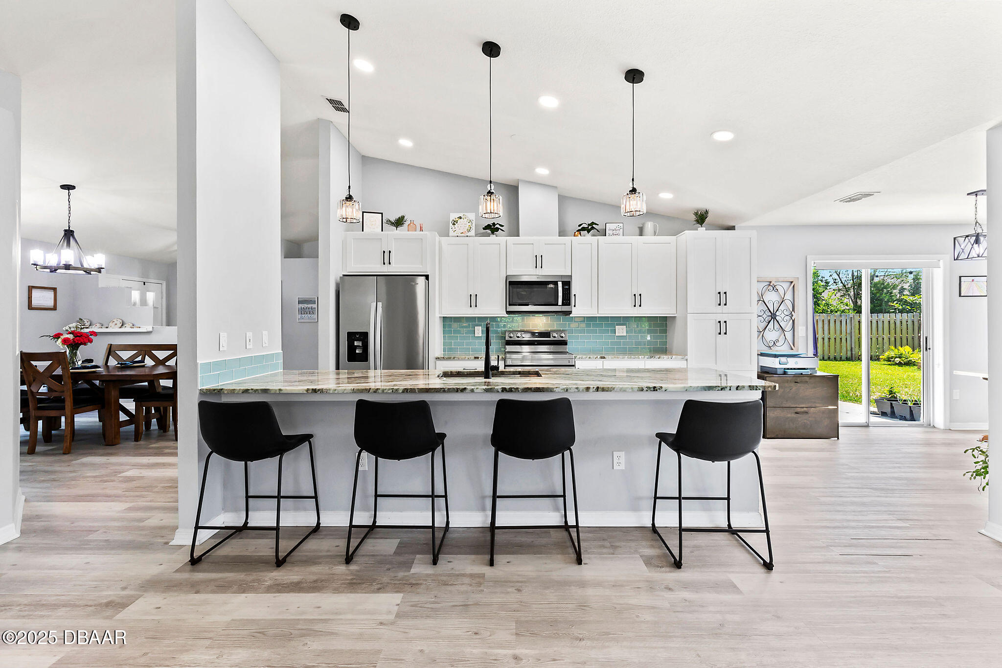 35 China Moon Drive Ormond Beach, FL 32174 - Photo 14 of 40 a kitchen with stainless steel appliances kitchen island granite countertop a table and chairs in it