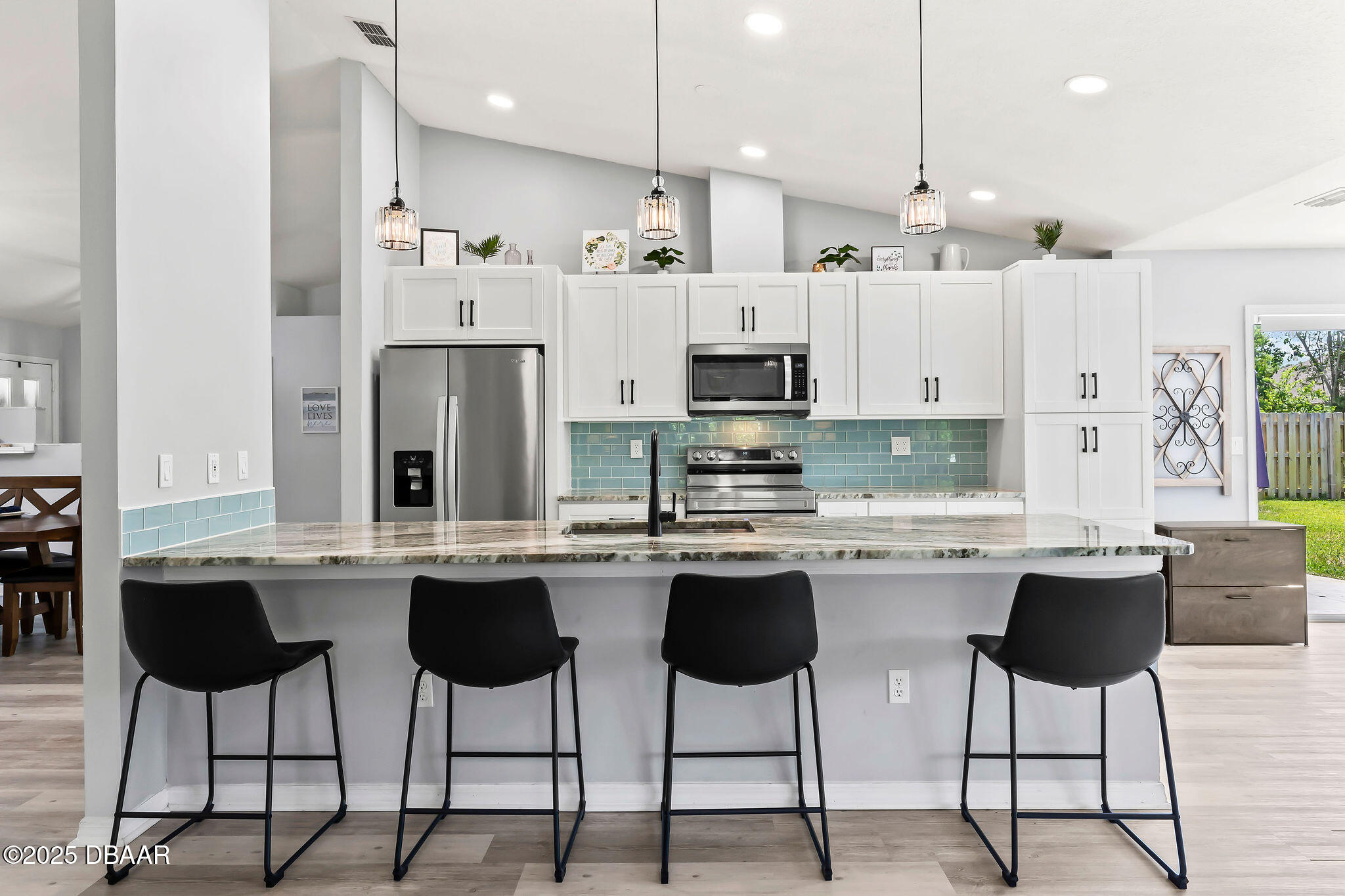 35 China Moon Drive Ormond Beach, FL 32174 - Photo 15 of 40 a kitchen with stainless steel appliances kitchen island granite countertop a table and chairs in it