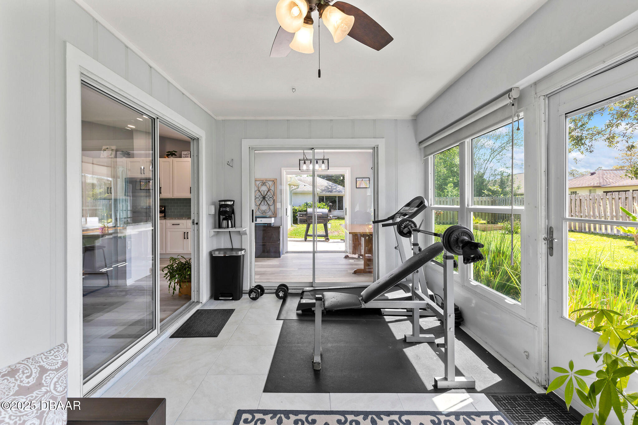 35 China Moon Drive Ormond Beach, FL 32174 - Photo 23 of 40 a living room with furniture floor to ceiling windows and a chandelier