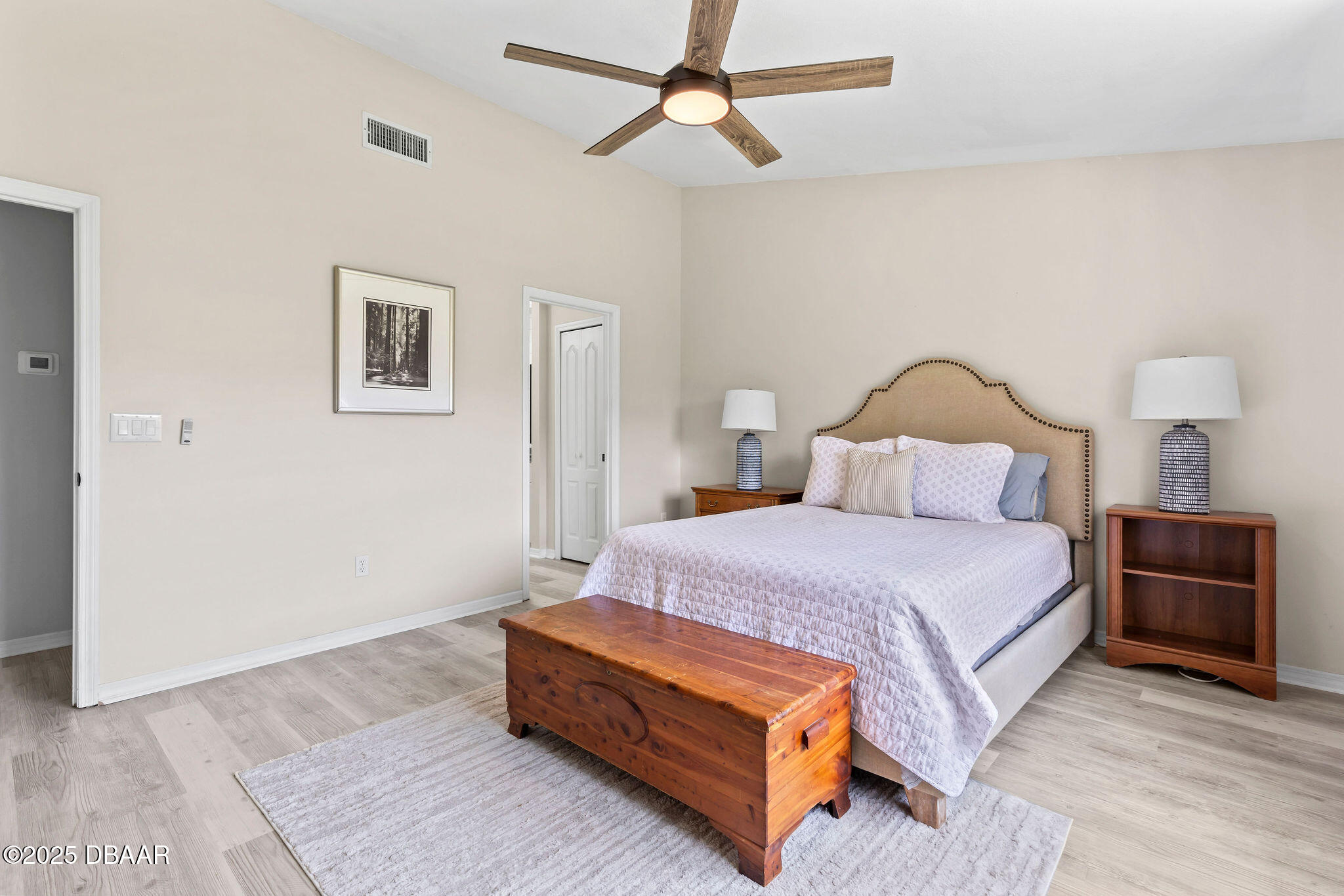 35 China Moon Drive Ormond Beach, FL 32174 - Photo 25 of 40 a bedroom with a bed a lamp and a chandelier