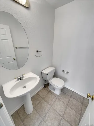a white toilet sitting next to a bathroom sink