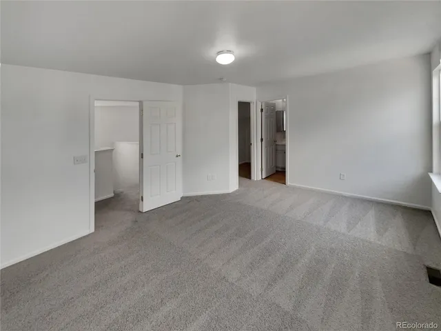 a view of an empty room with a closet