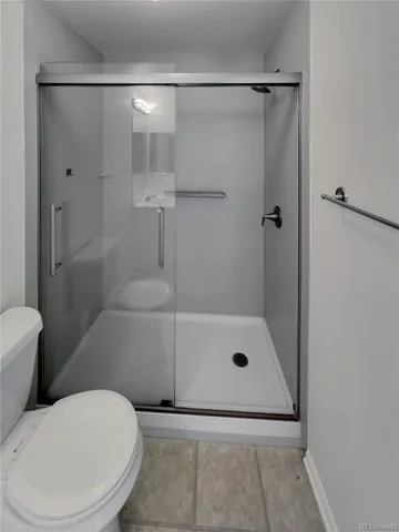 a bathroom with a shower and toilet