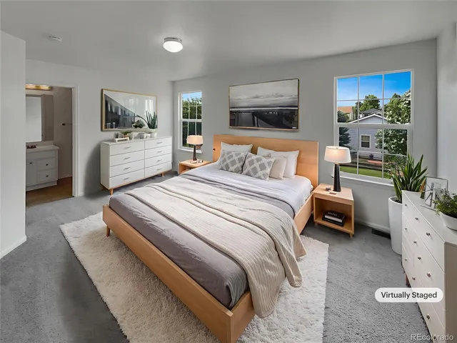 a bedroom with a bed a couch and dresser