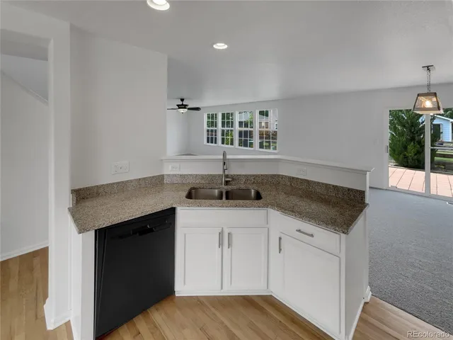 a kitchen with granite countertop a sink and cabinets