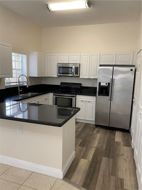 16150 Emerald Cove Road, Unit 16150 Weston, FL 33331 - Photo 2 of 17 a kitchen with stainless steel appliances granite countertop a sink and a microwave