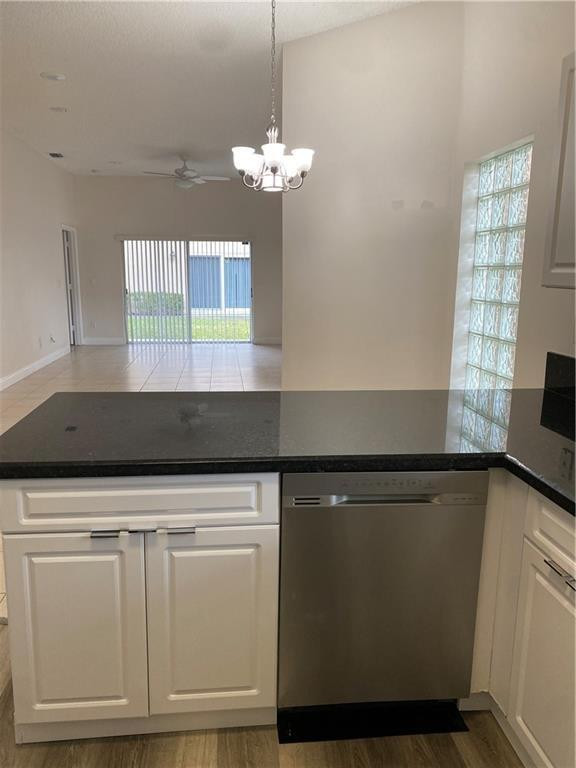 16150 Emerald Cove Road, Unit 16150 Weston, FL 33331 - Photo 3 of 17 a kitchen with granite countertop a stove a sink and a microwave