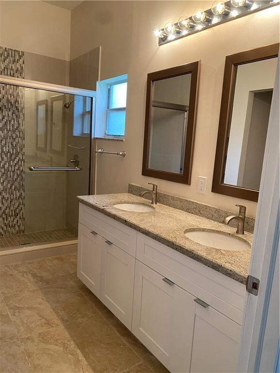 16150 Emerald Cove Road, Unit 16150 Weston, FL 33331 - Photo 6 of 17 a bathroom with a double vanity sink and mirror