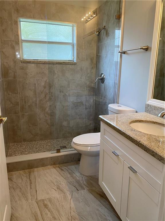 16150 Emerald Cove Road, Unit 16150 Weston, FL 33331 - Photo 9 of 17 a bathroom with a granite countertop sink a toilet and shower